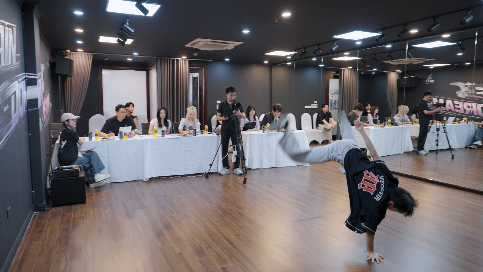 Judging panel and dancer on stage